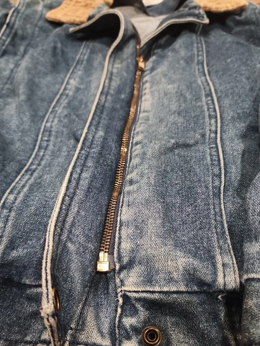 Vtg blue denim bomber jacket featuring a distinctive brown color